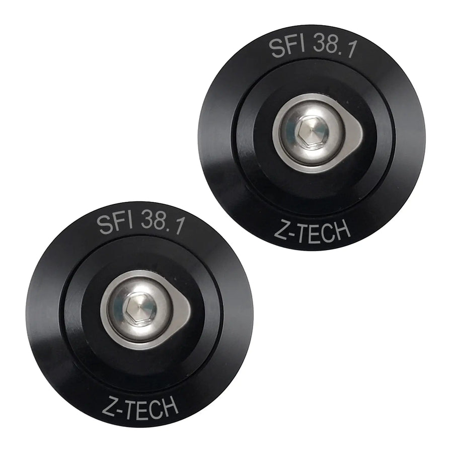 Two black Z-Tech series 8A helmet post anchors with SFI 38.1 certification on the top surface.